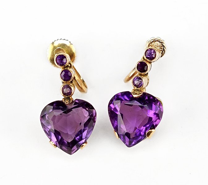A Pair Of Amethyst And 14 Karat Yellow Gold Earrings.: A Pair Of Amethyst And 14 Karat Yellow Gold Earrings. Each screwback earring contains a heart shaped prong set amethyst suspended from three stacked bezel set round amethysts Length: 1" Weight: 8.9 gr