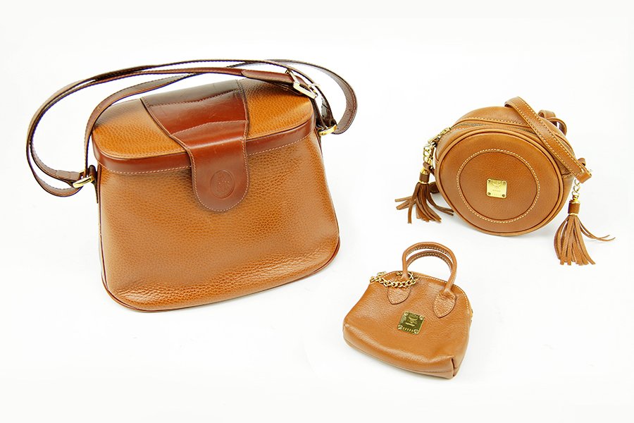 A Mark Cross Leather Shoulder Bag.: A Mark Cross Leather Shoulder Bag. Together with an MCM leather crossbody circle form bag and an MCM leather coin purse. Each bag bears goldtone hardware Mark Cross: 7" x 10"