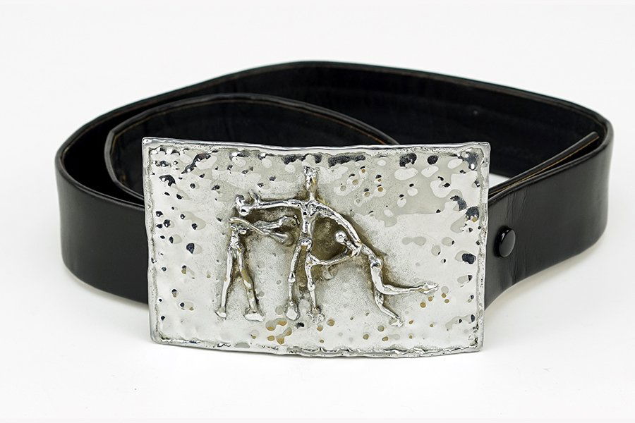 A Pal Kepenyes Belt Buckle.: A Pal Kepenyes Belt Buckle. Silverplate metal buckle depicting three figures. Unsigned. Together with a black leather belt Buckle: 2.75" x 4.5"