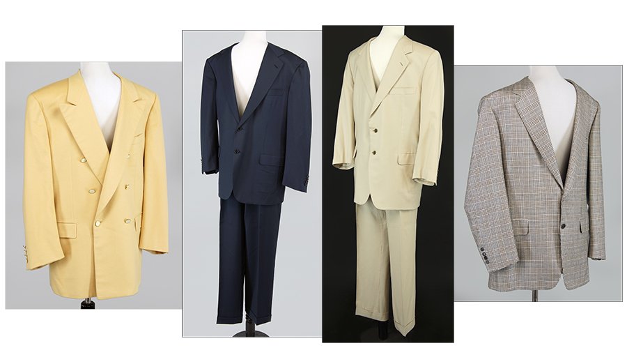 Two Brioni Suits.: Two Brioni Suits. Together with two Brioni wool jackets. Houndstooth Jacket: 44, Yellow Jacket: 44, Navy Suit: Jacket - 44 | Pants - 38, Tan Suit: Jacket - 48 | Pants - 42