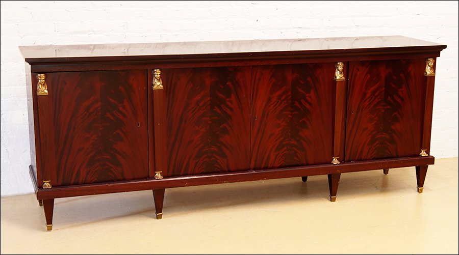 A Flame Mahogany Credenza.: A Flame Mahogany Credenza. Bearing caryatid form ormolu mounts throughout. With key 38" x 97" x 22"