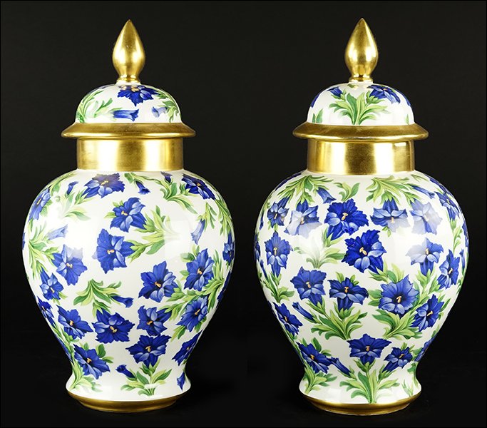 A Pair of Transfer Decorated Bavarian Porcelain Lidded: A Pair of Transfer Decorated Bavarian Porcelain Lidded Urns. Bearing gilt accents and a 'Bavaria Schumann' mark on the undersides Height: 14"