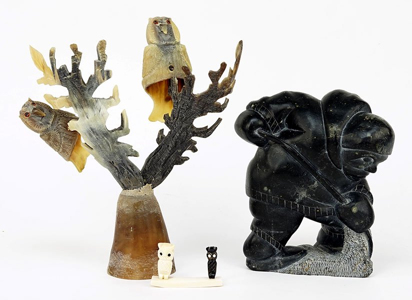 An Inuit Stone Carving of an Ice Fisherman.: An Inuit Stone Carving of an Ice Fisherman. Together with a carved horn owl grouping, and a carved bone and horn owl object Fisherman height: 7.5"
