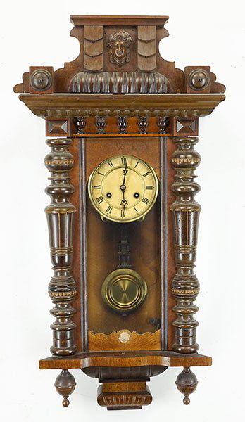 A German Carved Walnut Wall Clock.: A German Carved Walnut Wall Clock. Face reads "Unghans". With pendulum. Susanin's will not comment on the working condition of any watch or clock movement Case: 32" x 16" x 8"