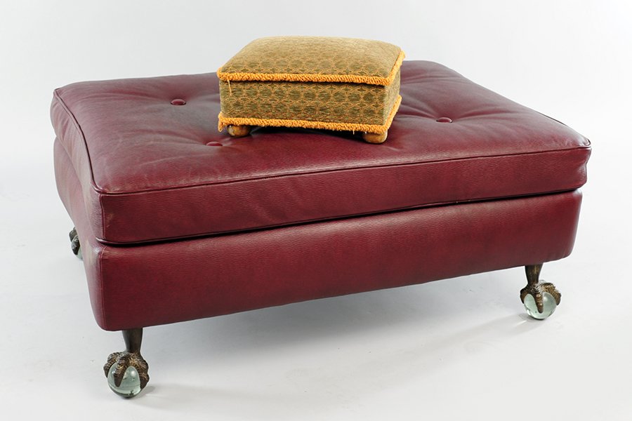 An Edelman Leather Upholstered Ottoman.: An Edelman Leather Upholstered Ottoman. Raised on ball and claw feet holding lucite spheres. Together with a lift top upholstered footstool with interior storage compartment 18" x 41" x 30"
