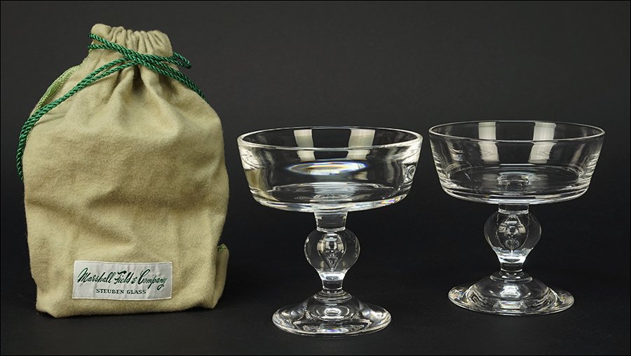 A Set of Twelve Steuben Champagne / Sherbet Glasses.: A Set of Twelve Steuben Champagne / Sherbet Glasses. All signed on the underside, each with the original 'Marshall Field & Co.' dustbag Each: 4.25" x 4"
