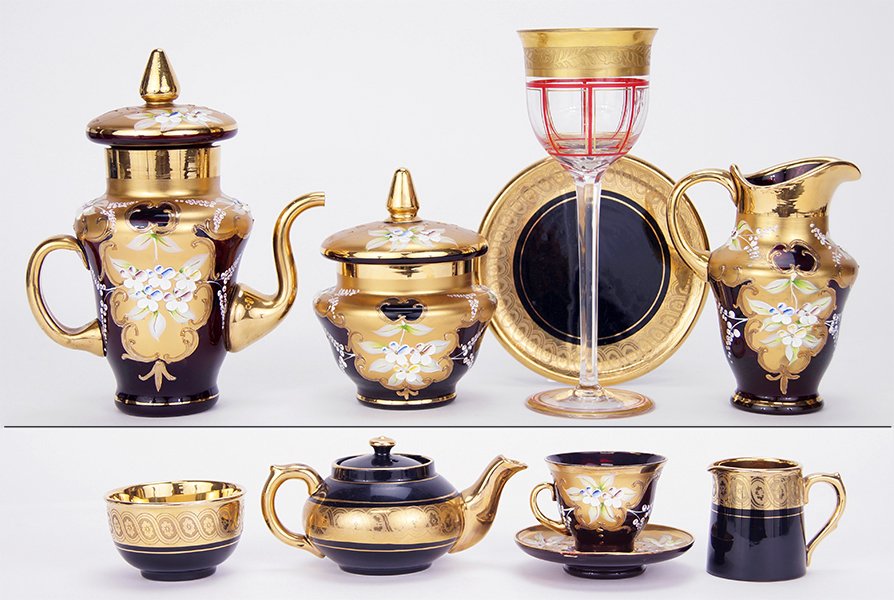 A Bohemian Enameled Cranberry Glass Tea Service.: A Bohemian Enameled Cranberry Glass Tea Service. Comprising a teapot, creamer, covered sugar bowl and five teacups and saucers. Together with a Gibson and Sons Sevres Davenport individual tea service 