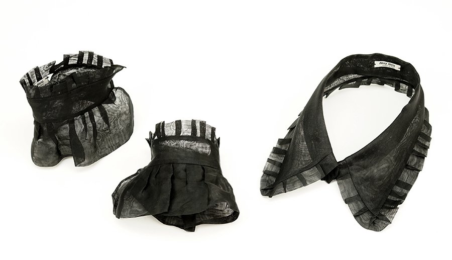 A Suite of Miu Miu Accessories.: A Suite of Miu Miu Accessories. Comprising a black organdy collar and pair of cuffs trimmed in pleated organdy with snap closures. Together with original Miu Miu box