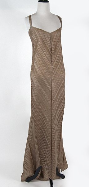 An Issey Miyake Champagne Pleated Evening Gown.: An Issey Miyake Champagne Pleated Evening Gown. V-neck with adjustable straps and rear train extending from the waist Size 3