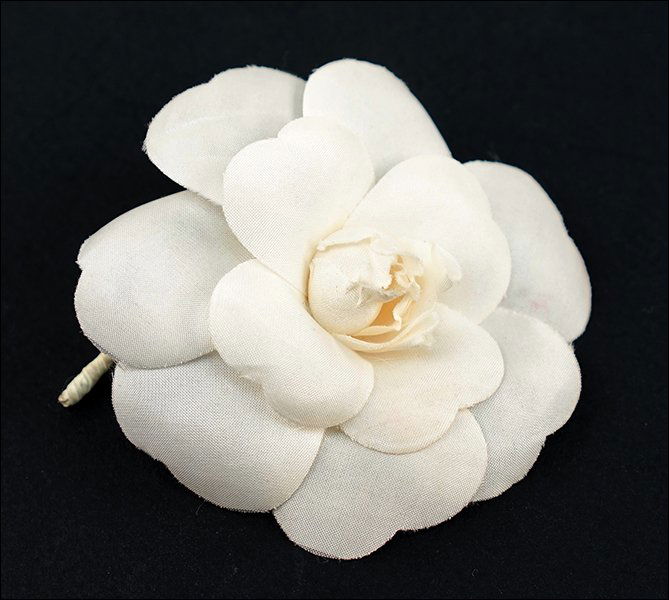 A Chanel White Flower Pin. (1 of 2)