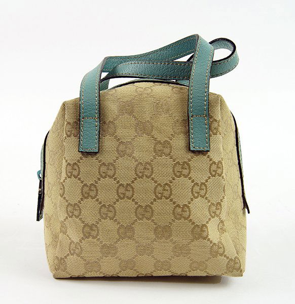 A Gucci Monogrammed Canvas and Leather Handbag. (1 of 1)