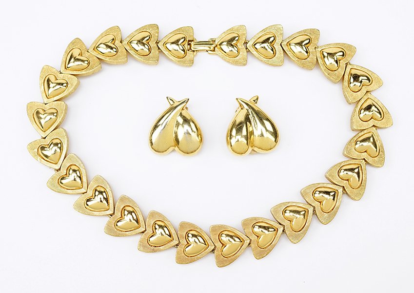 An Escada Goldtone Demi-Parure.: An Escada Goldtone Demi-Parure. Comprising a heart link necklace and pair of heart earclips. Necklace is stamped "Escada Made in France". With original heart shaped box Necklace length: 15.5"