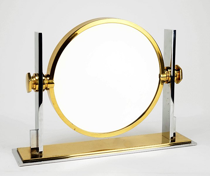 A Karl Springer Chrome and Brass Vanity Mirror.: A Karl Springer Chrome and Brass Vanity Mirror. Overall: 15.25" x 21" x 5" Mirror diameter: 13.5"