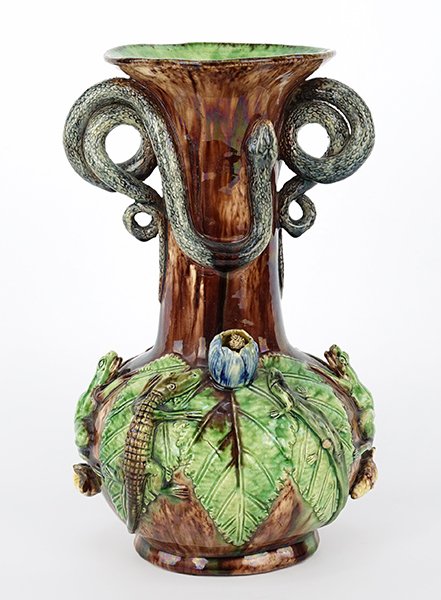 A Manuel Mafra Palissy Ware Vase.: A Manuel Mafra Palissy Ware Vase. Portuguese majolica vase with applied snake handles above a bulbous lower half decorated with green leaves, lizards, frogs, shells and flower blossoms. Underside is i