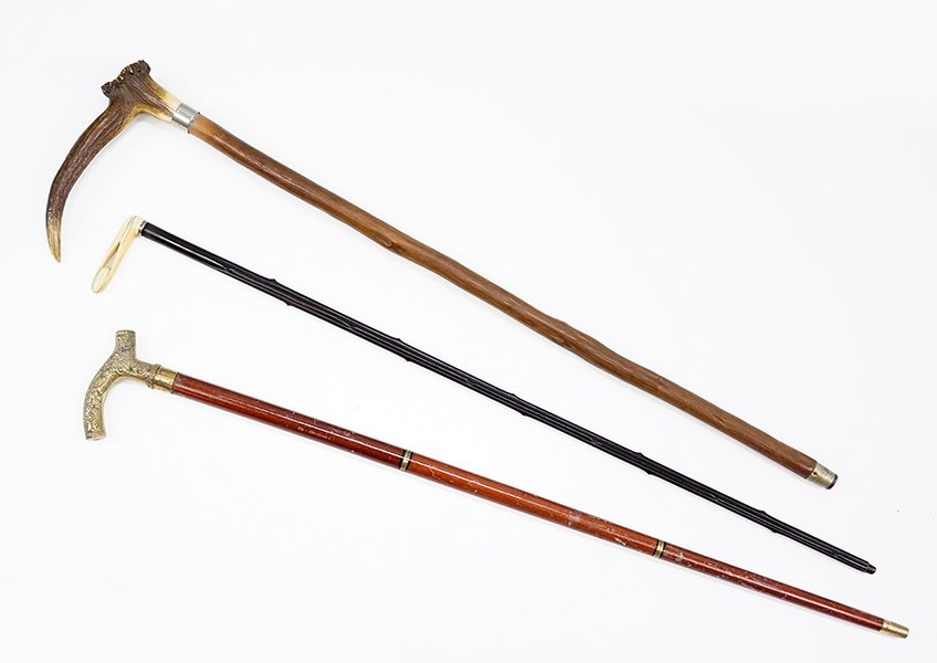 An Antler Handled Cane.: An Antler Handled Cane. Together with a carved ivory handled cane, and a brass handled cane (Length: 35")