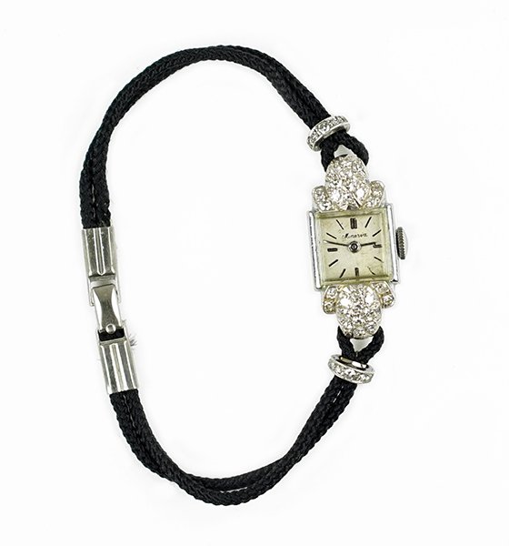 A Lady's Minerva Diamond Watch.: A Lady's Minerva Diamond Watch. White gold mounting containing pave set diamonds. Reverse of case is stamped "Invicta Fond Acier Inoxydable 22400". Susanin's will not comment on the working condition