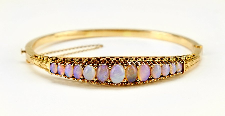 An Opal and 14 Karat Yellow Gold Bangle Bracelet. (1 of 1)