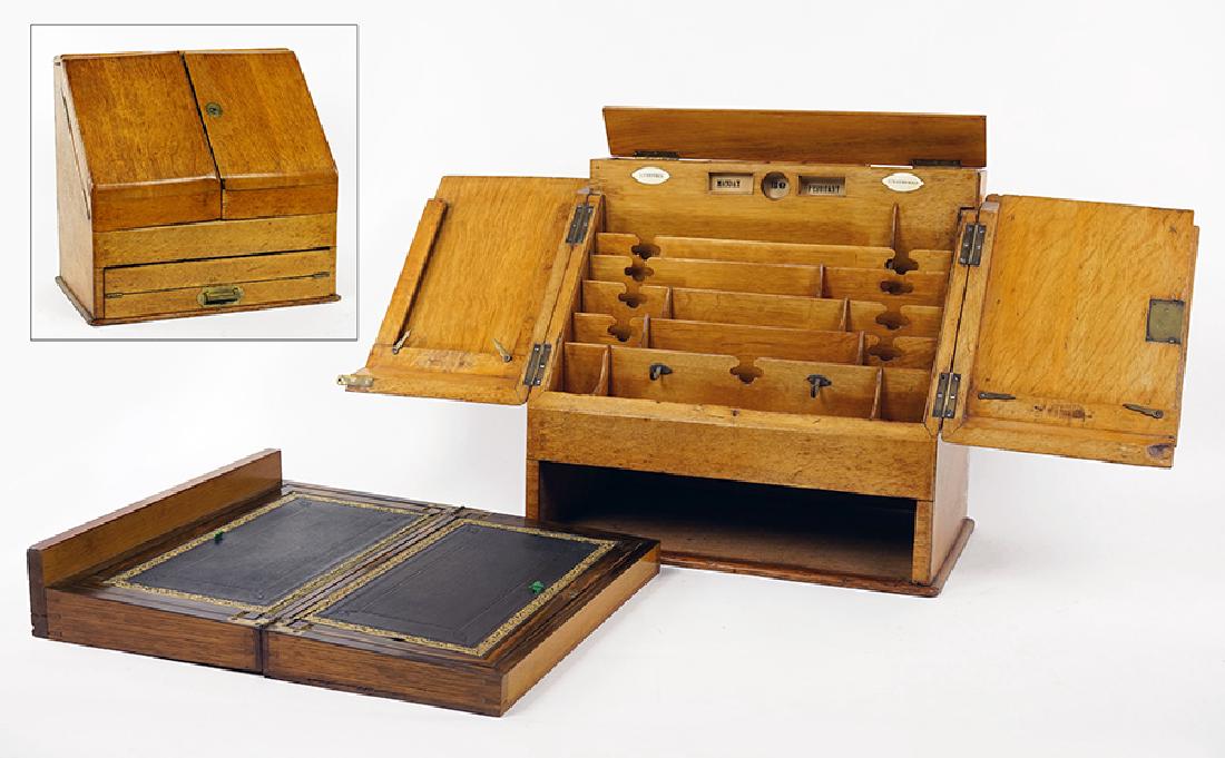 A 19th Century English Oak Portable Secretary.: A 19th Century English Oak Portable Secretary. Hardware is marked Bramah, London. Bearing ivory date markers and a removable lap desk 16" x 17.25" x 10"