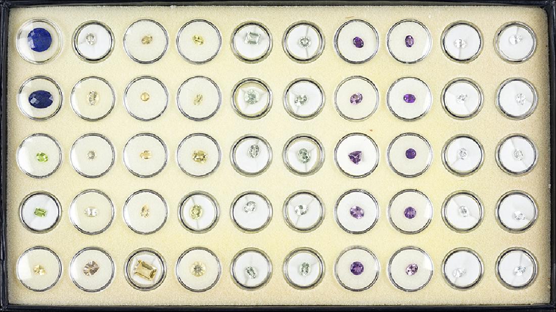 A Collection of Loose Gemstones.: A Collection of Loose Gemstones. Comprising lapis, amethyst, white topaz, prasiolite, golden beryl, and others