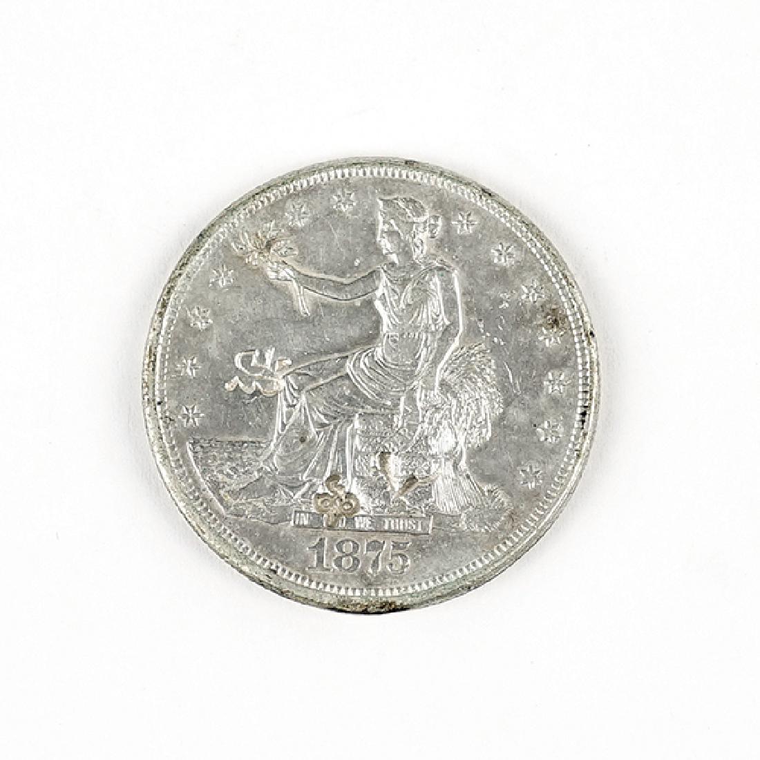 An 1875-CC Seated Liberty Trade Silver Dollar. (1 of 2)