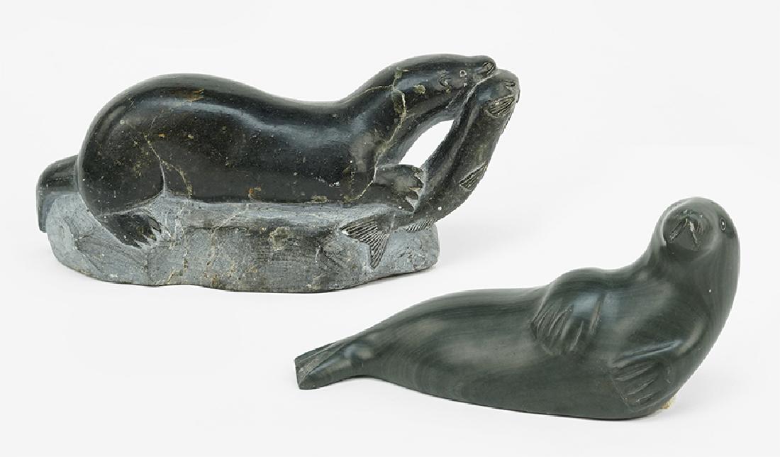 Two Inuit Carvings.: Two Inuit Carvings. One depicting a recumbent seal, and the other a seal with fish in the mouth (3.5" x 8" x 2.5") Seal: 3.5" x 8" x 2.5"