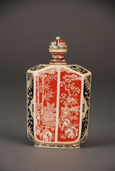C19th Oriental painted ivory snuff bottle, of flattened: C19th Oriental painted ivory snuff bottle, of flattened octagonal shape, decorated on the main sides with panels of flower sprays and rockwork on a painted red ground, matching stopper, 7.5H