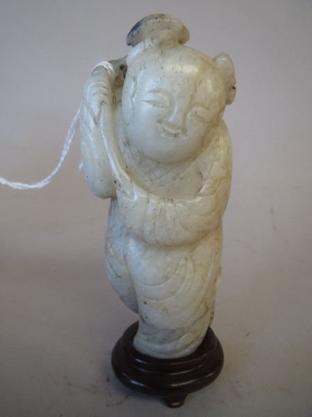 Ming-style Chinese mutton fat carved jade figure of a: Ming-style Chinese mutton fat carved jade figure of a boy holding lingzhi, 8H hardwood stand
