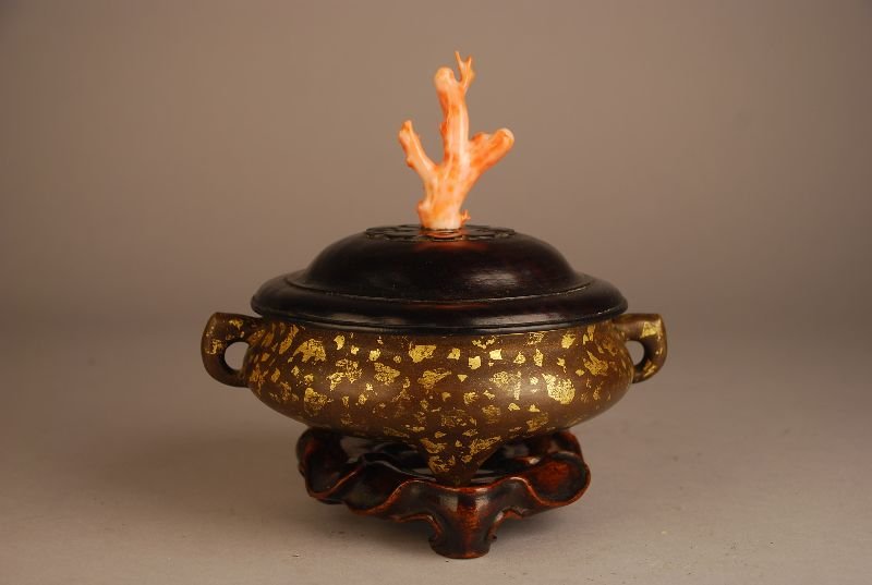 Chinese gilt-splashed tripod censer, with compressed: Chinese gilt-splashed tripod censer, with compressed globular body and c-shaped handles raised on three conical supports decorated with gilt splashes to contrast against the olive patina, Xuande mark 