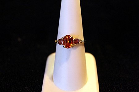 Rare Padparadsha Sapphire 14kt Ring GIA $14,650.00: Lady's Solid 14K Yellow Gold Padparadsha Sapphire Ring, oval facet rare padparadsha sapphire, rurrounded by 2 basal set round brilliant padparadsha sapphires. Sapphires approx twt 2.06 cts, total weig