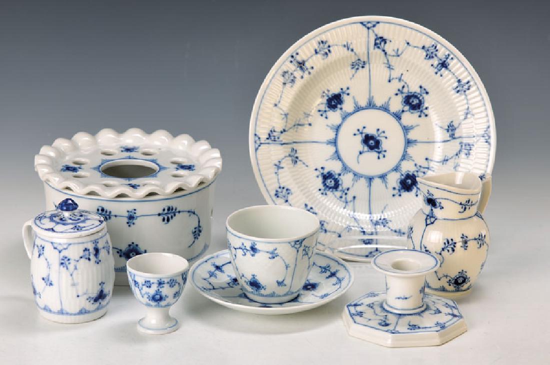23 parts of tableware: 23 parts of tableware, Royal Copenhagen and Bing & Gröndahl, with blue floral decor under the glaze, warmer, 4 egg cups (1 with minor dam.), mustard pot (dam.), Candlestick, 5 cupswith 6 saucers, mil
