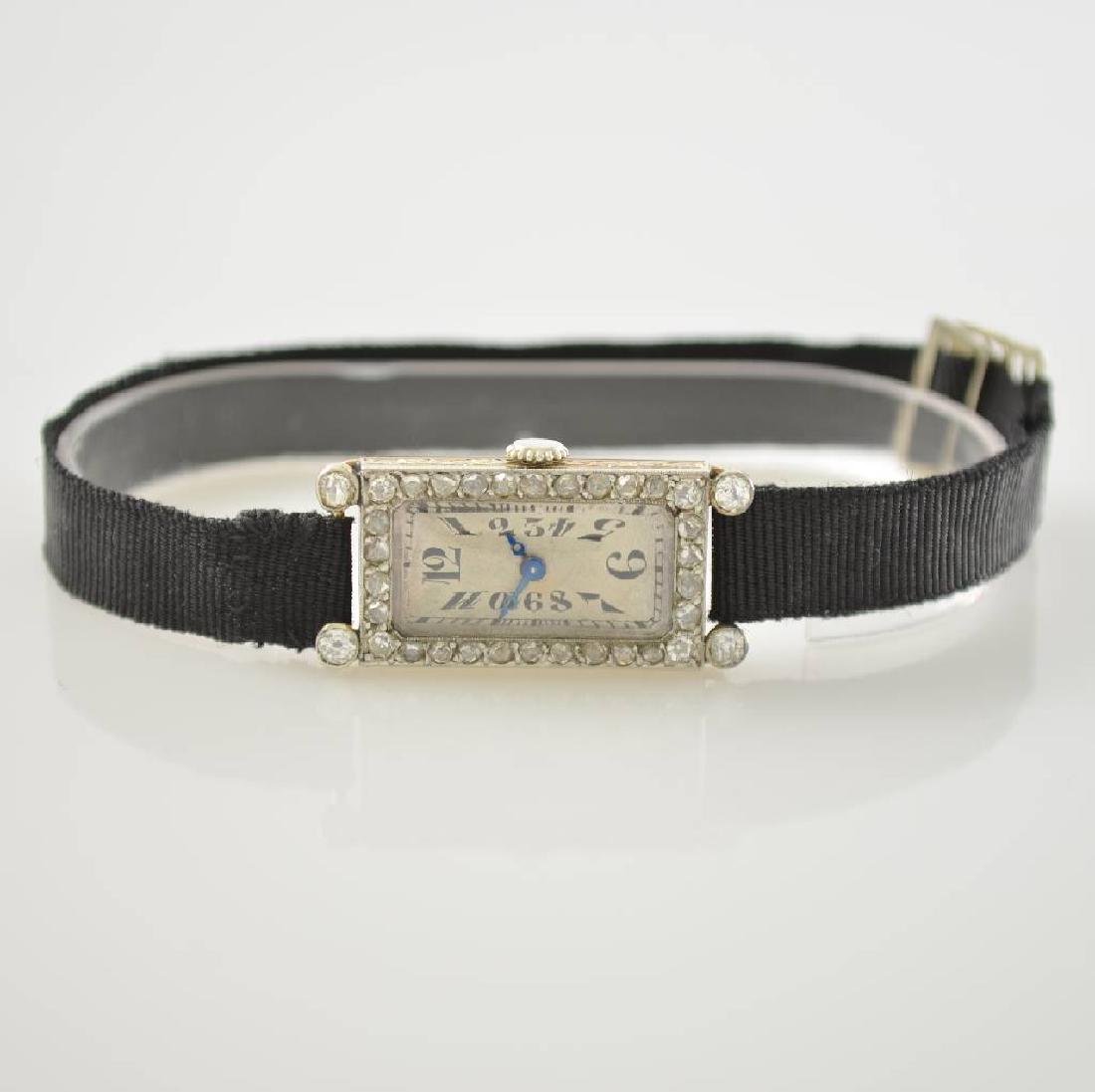 Art Deco 18k white gold ladies wristwatch with diamonds: Art Deco 18k white gold ladies wristwatch with diamonds, Switzerland around 1925, manual winding, snap on case back, bezel lavish diamonds set, textile strap with 18k white gold buckle, silvered dial
