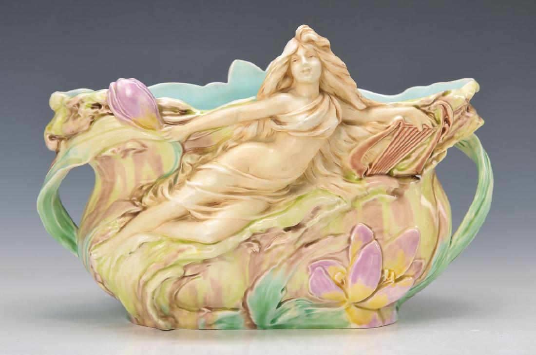Jardiniere, Royal Dux, around 1900-1910, earthenware: Jardiniere, Royal Dux, around 1900-1910, earthenware, opulent embossed with water lilies and female figure, painted in bright colors, minor rim damage, approx. 21x31x15cm