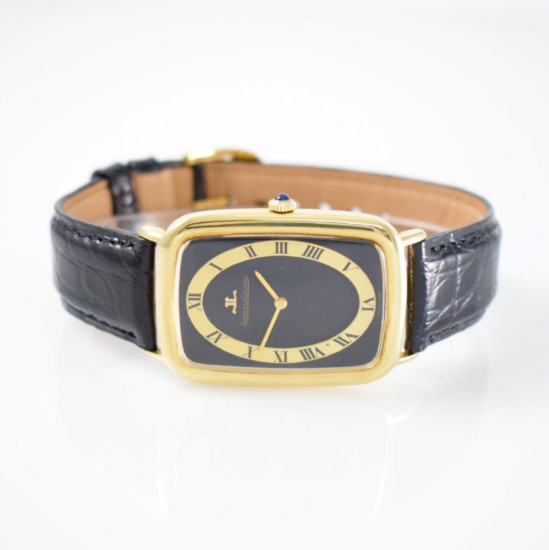 Jaeger-LeCoultre large 18k yellow gold gents wristwatch: Jaeger-LeCoultre large 18k yellow gold gents wristwatch reference 9046, Switzerland around 1975, manual winding, black dial with gilded numbers ring dent, Roman hour-indexes, gilded hands, jeweled cro