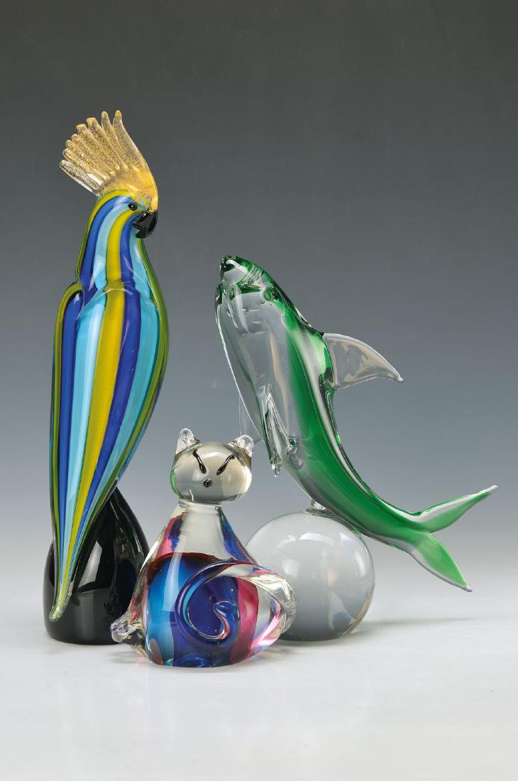 3 animal sculptures, Murano Italy, 20th c., cockatoo: 3 animal sculptures, Murano Italy, 20th c., cockatoo, yellow-blue and light blue striped, comb with gold dust powdering, H. approx. 33.5cm ; cat, H. approx. 14cm, dolphin with green inside, H. approx.