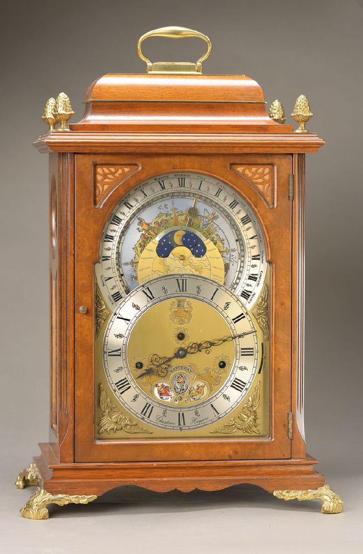 table clock, Model Christiaan Huygens, Made in The: table clock, Model Christiaan Huygens, Made in The Netherlands, around 1960/70, wood housing in Baroque style, display/ date/ weekday/ month/ phase of the Moon/ Universal Time, 3 winders, stroke Melod