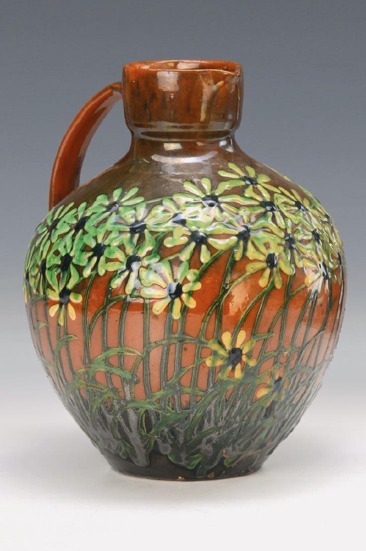 handle vase, Max Läuger, Kunstkeramikwerke Kandern: handle vase, Max Läuger, Kunstkeramikwerke Kandern, 1886, firing H., No. 17, ceramic, brown clay, embossment decor, blossoms white- green on red brown ground, handle matching theflower structure, red