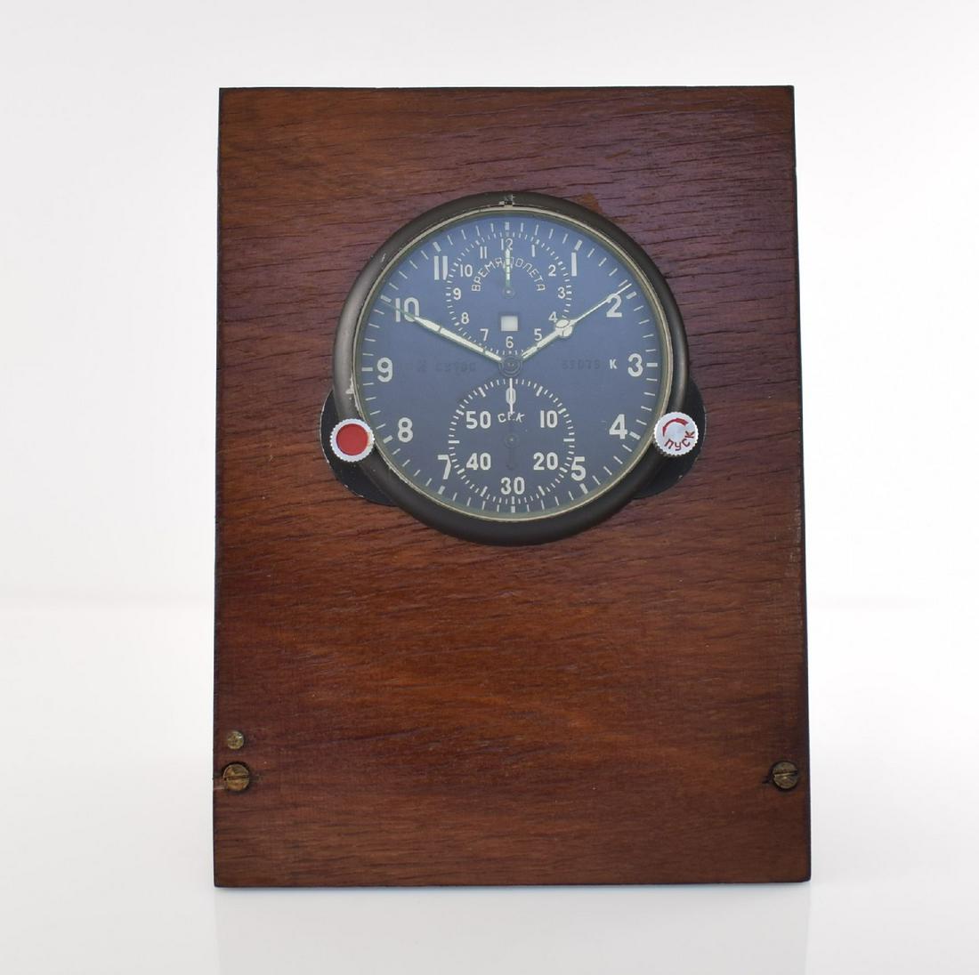 Aircraft clock for MIG 29 with chronograph on wooden: Aircraft clock for MIG 29 with chronograph on wooden base, Soviet Union 1980´s, metal case hermetic screwed down, mineral glass, contrast dial, 2-days-movement, 60-minutes-counter, 2-time, heating co