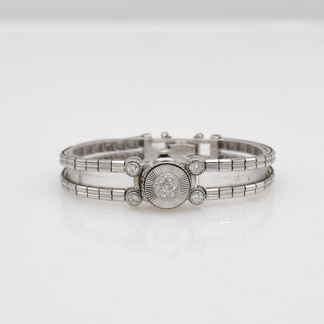 HAMILTON unusual 14k white gold ladies wristwatch: HAMILTON unusual 14k white gold ladies- wristwatch, manual winding, USA approx. 1954, cover & lugs diamonds set, snap on case back, silvered dial due to age spotty, blued steel hands, lever movement,