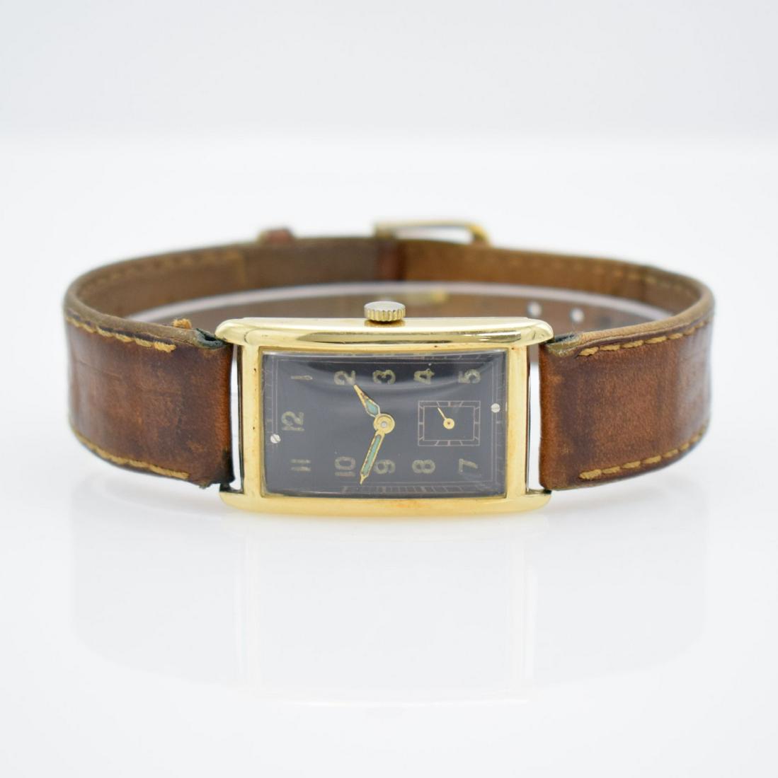 14k yellow gold Gents wristwatch: 14k yellow gold Gents wristwatch, Switzerland around 1935, manual winding, hinge case, snap on case back, black dial with Arabic numerals, gilded hands, lever movement, 15 jewels, measures approx. 37 