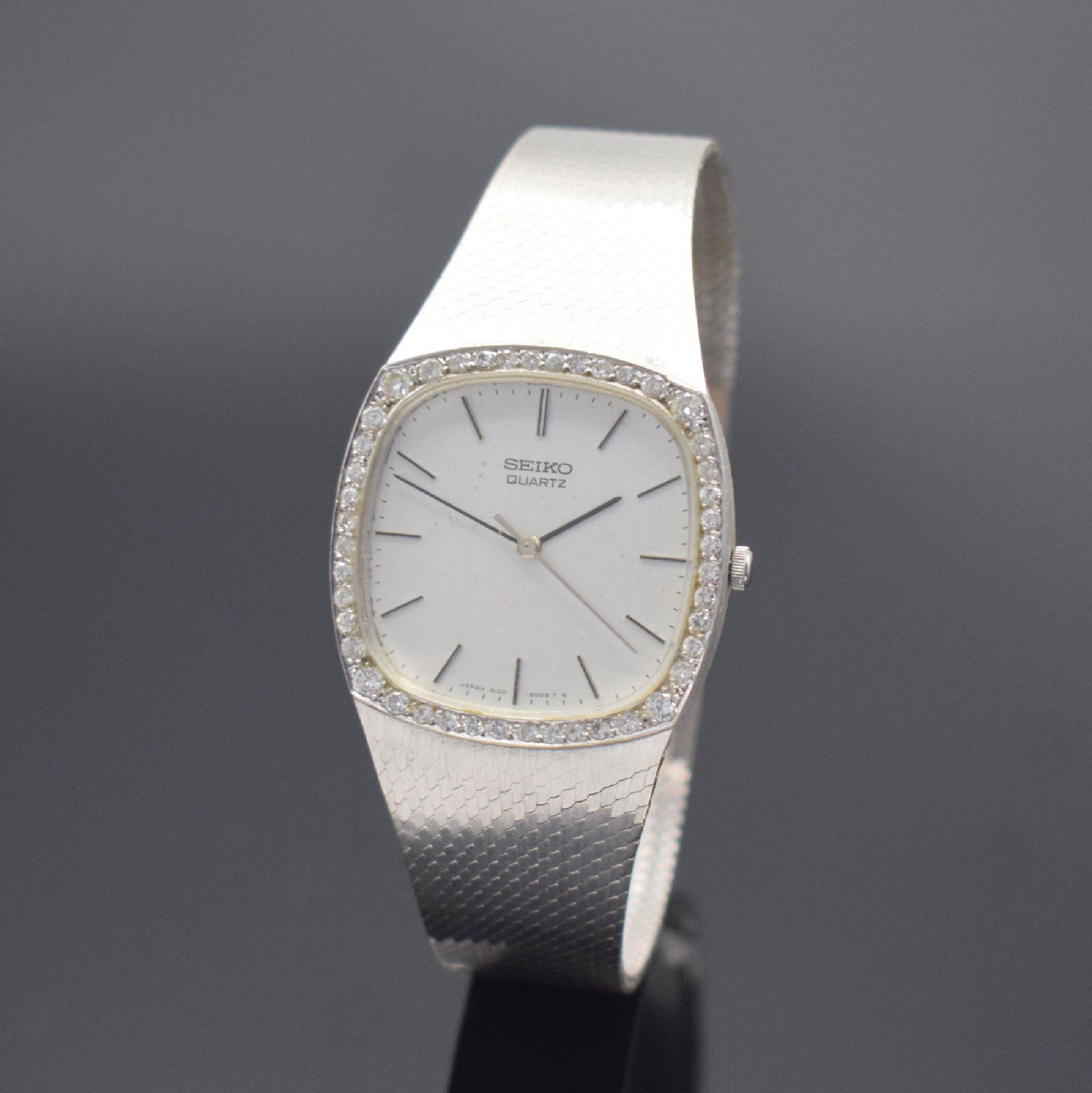 SEIKO 14k white gold wristwatch, Japan 1970's: SEIKO 14k white gold wristwatch, Japan 1970's, quartz, snap on case back, bezel lavish diamonds set, silvered dial with raised indices due to age spotty, display of hours, minutes and sweep seconds, c