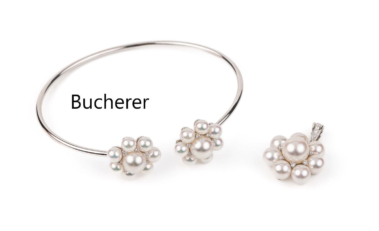 18 kt gold BUCHERER pearl-diamond-jewelry set: 18 kt gold BUCHERER pearl-diamond-jewelry set , WG 750/000, comprised of: 1 pendant with 8cultured akoya pearls, diam. approx. 5-7.5 mm,and 12 brilliants total approx. 0.07 ct Wesselton/vs, and 1 bang