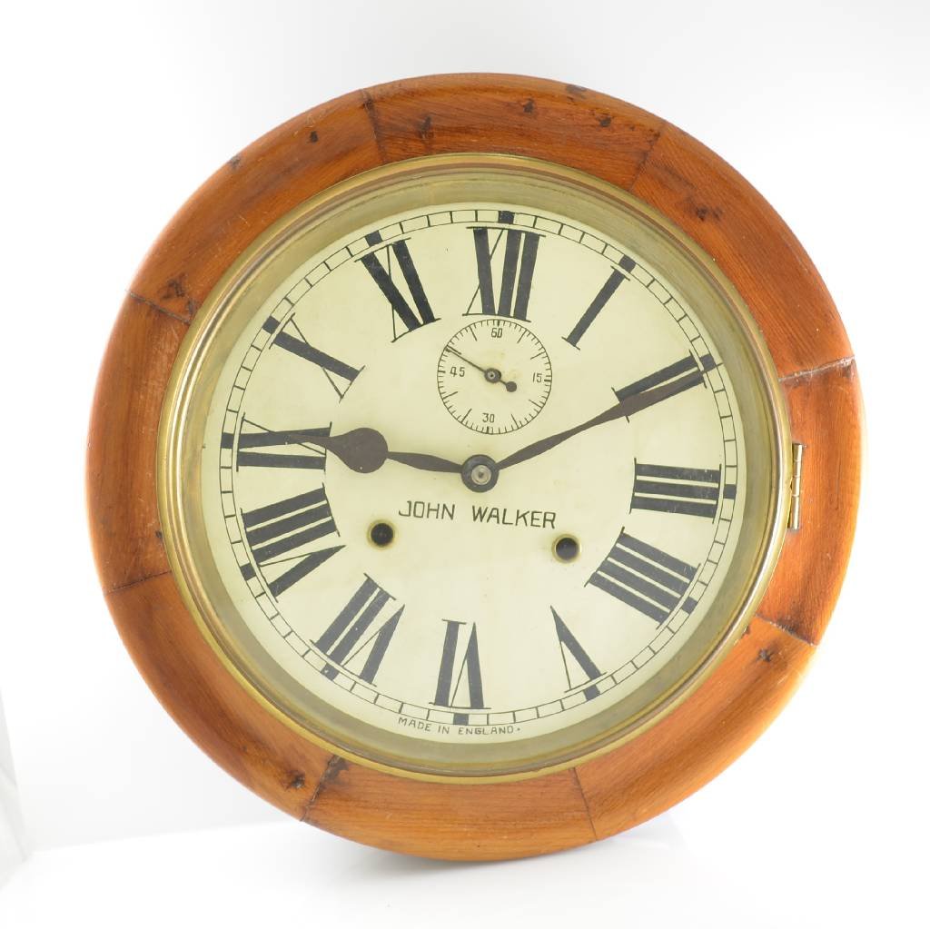 JOHN WALKER wall clock, England around 1930: JOHN WALKER wall clock, England around 1930, round wooden frame with glazed brass bezel, white metal dial with big roman numerals, small second at 12, black spade hands, brass movement, 1/2 hour-strik
