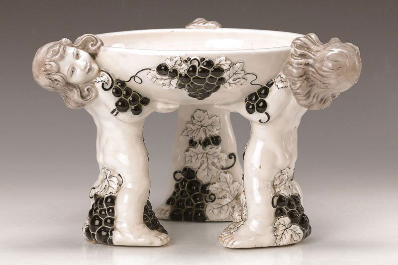 Centrepiece, Gmunden ceramics: Centrepiece, Gmunden ceramics, to 1920, 3 putti holding the bowl, Art Nouveau design to 1906-10, design Carl Klimt, stoneware, black painted, raised vine leaf decor, individualized faces, heightened g