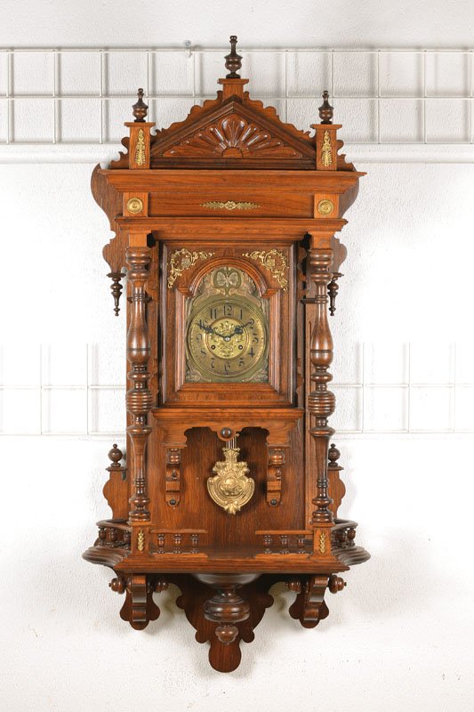 Large wall clock, German: Large wall clock, German, around 1900/1910, Wilhelminian style, with elaborate pieces of turned wood, molded, historism in its purest finishing, decorated brass appliqués, orig. top, installed clock