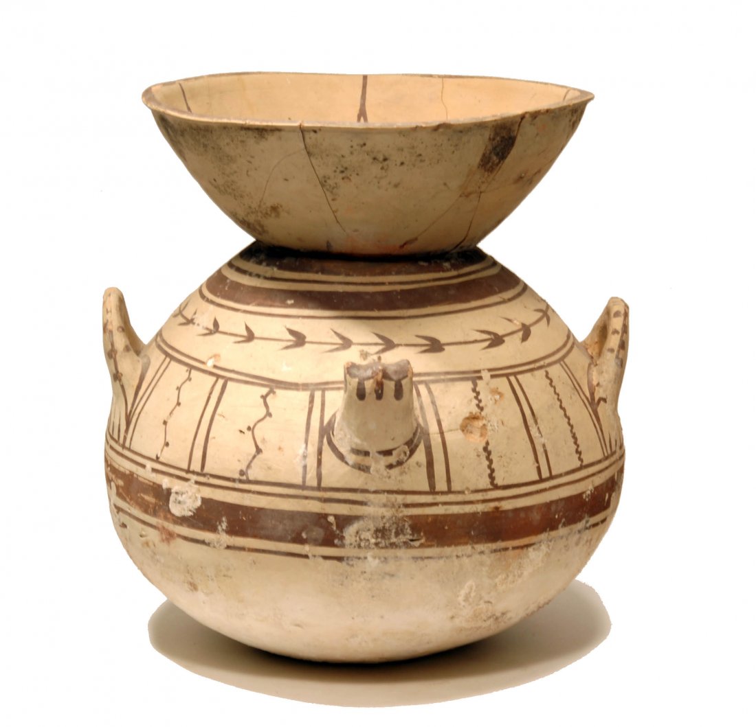 Ancient Daunian Pottery Funnel Krater: Ca. 350 BC, South Italy. A lovely ornate and delicate funerary vessel of large rounded body with broad funnel rim and four vertical ring handles. The decoration in added red and brown umber pigments i