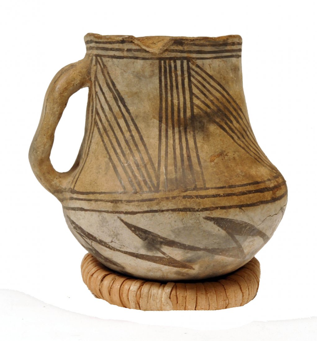 American Indian Anasazi Black on White Pottery Mug: New Mexico, Southwest US, Ca. 1100 to 1300 AD. This mug, expertly created by the Anasazi artisans of the Chaco Canyon area, is particularly striking for its black on white design of thin stripes. Heig