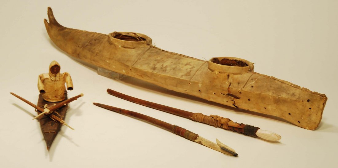 American Indian Inuit Model Canoe & Kayak: Arctic Coast Indians, probably Greenland, Ca. 19th Century. The smaller with a figure pinned into the kayak, wood and bone harpoons attached to the prow, the person wearing hide anorak and hands exten
