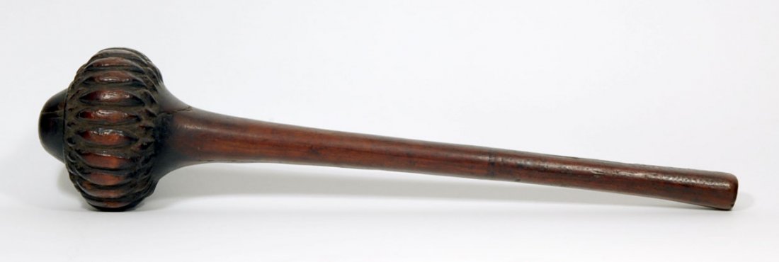 Throwing Club from Fiji Islands: A wooden throwing club from the Fiji Islands, reddish brown patina, a rounded club head with sculpted details and simple short handle. Length: 16 inches. Ex. private Brooklyn collection.