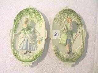 Pr. Occupied Japan Wall Figurines.: This pair is 7-1/8" high and 4-3/8" wide. Both plaques are 3 dimensional. The lady is carrying a basket of flowers and the man has his hat in one hand and his walking stick in the other. The backs