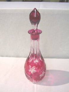 Cranberry & Clear Etched Decanter with Stopper: Decanter is 12-1/4" high. It has leaf & grape clusters etched to clear. Decanter is in good condition with some minor areas of imperfection.